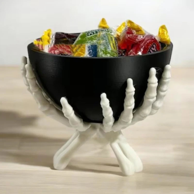 Gothic skeleton hand Halloween candy bowl holding wrapped treats