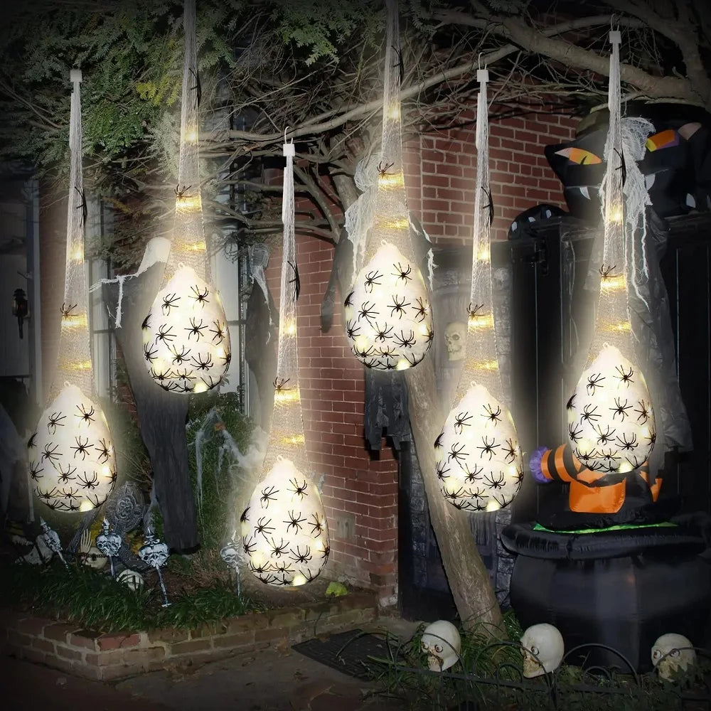 Hanging Halloween spider egg sac prop glowing in the dark