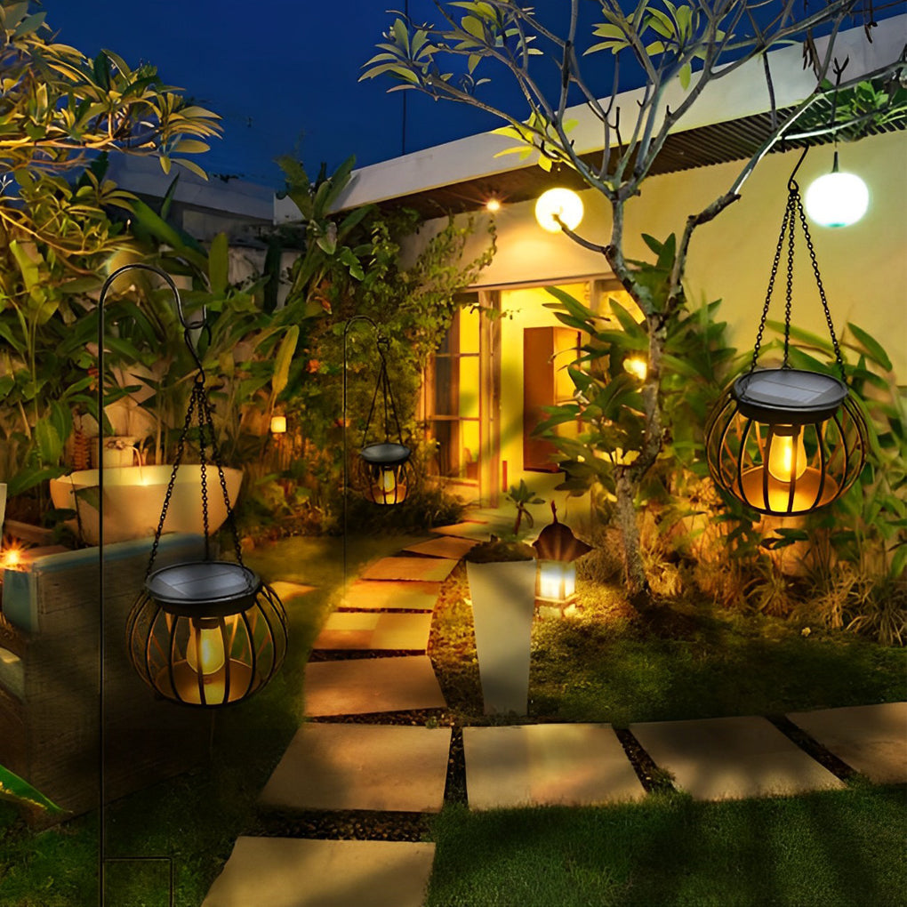 Modern metal pumpkin lantern with LED light on a garden path
