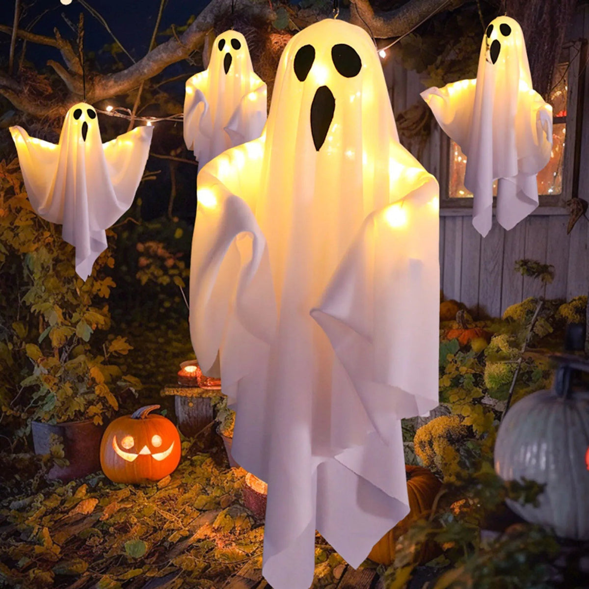 Glowing hanging ghost Halloween decoration lit up in the dark