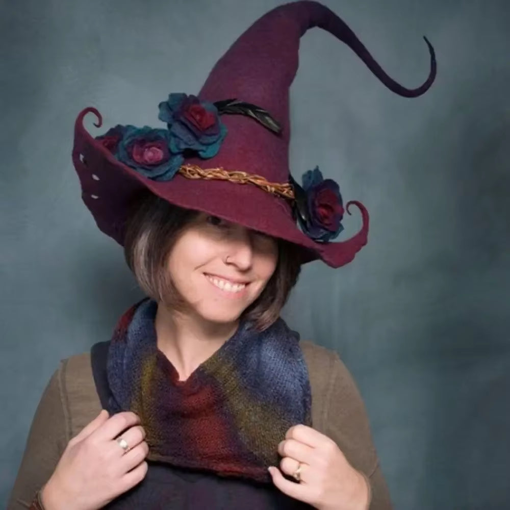 Wet felted witch hat shown from the side with a tall pointed crown