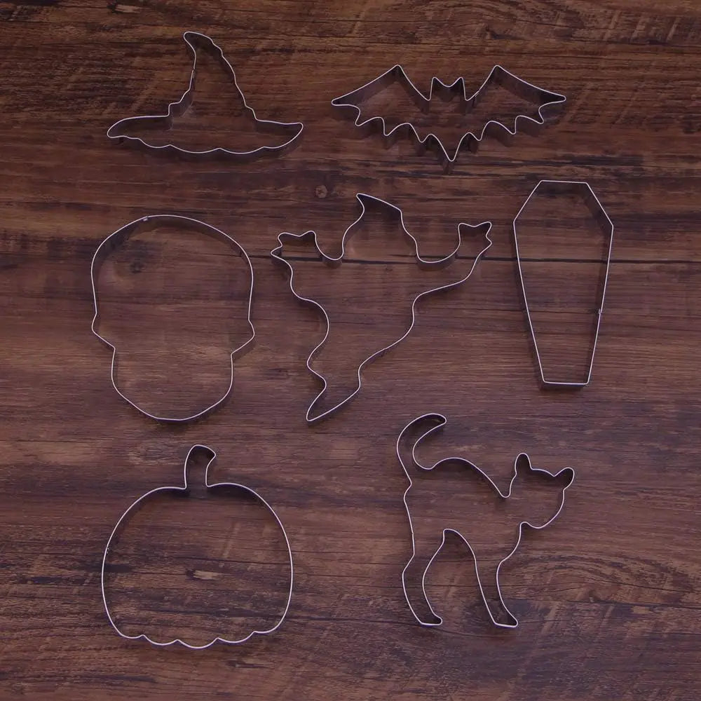 Halloween cookie cutters in witch hat, bat, and ghost shapes