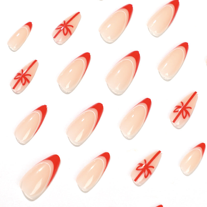 Stiletto Christmas Nails with Red Tips and Bow Motifs | Acrylic Press On Nail Set | Festive Manicure for Winter Parties