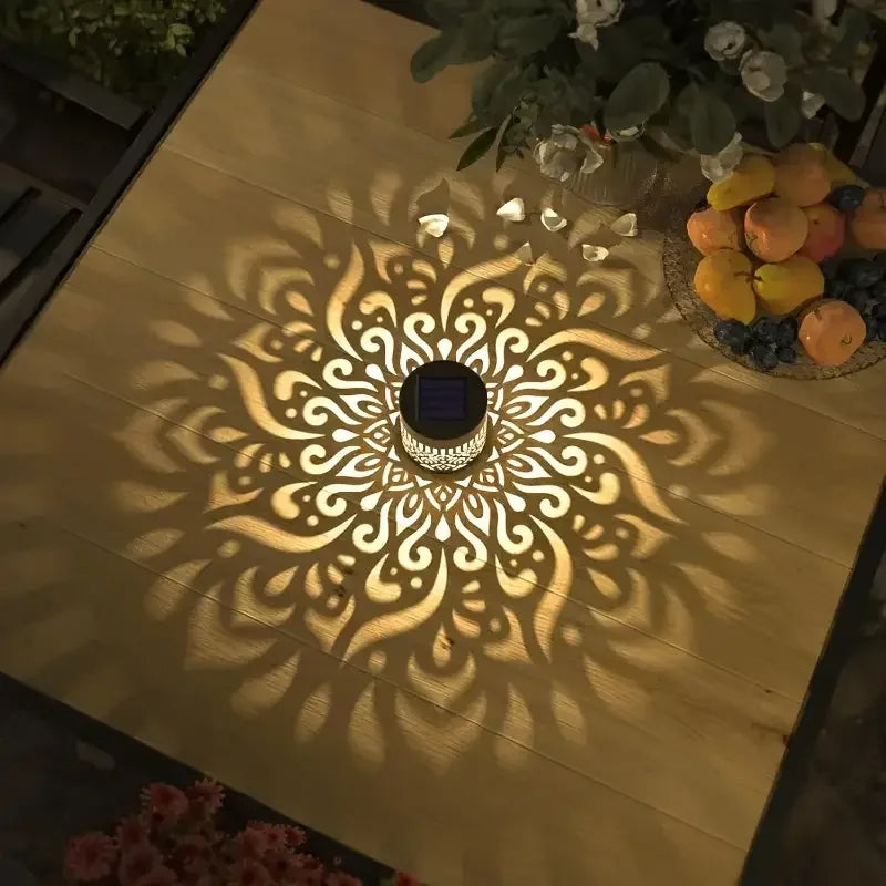 Solar outdoor wall light with hollow cutout pattern mounted by a front door