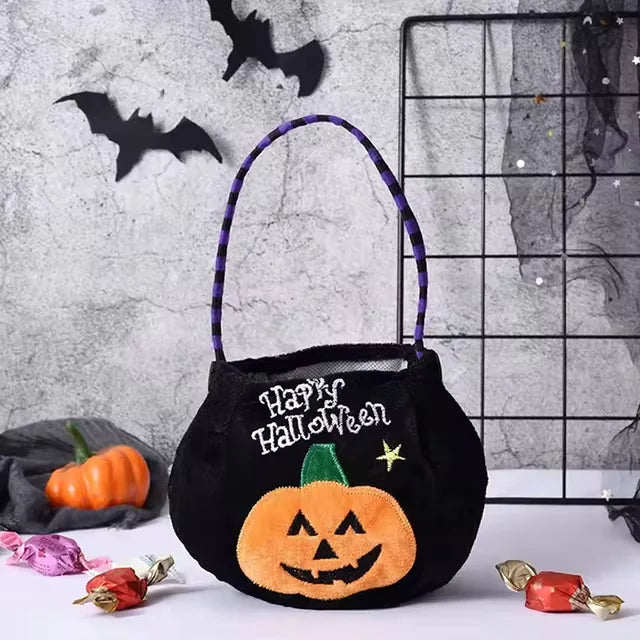Black pumpkin-shaped Halloween treat bag for kids with adjustable strap
