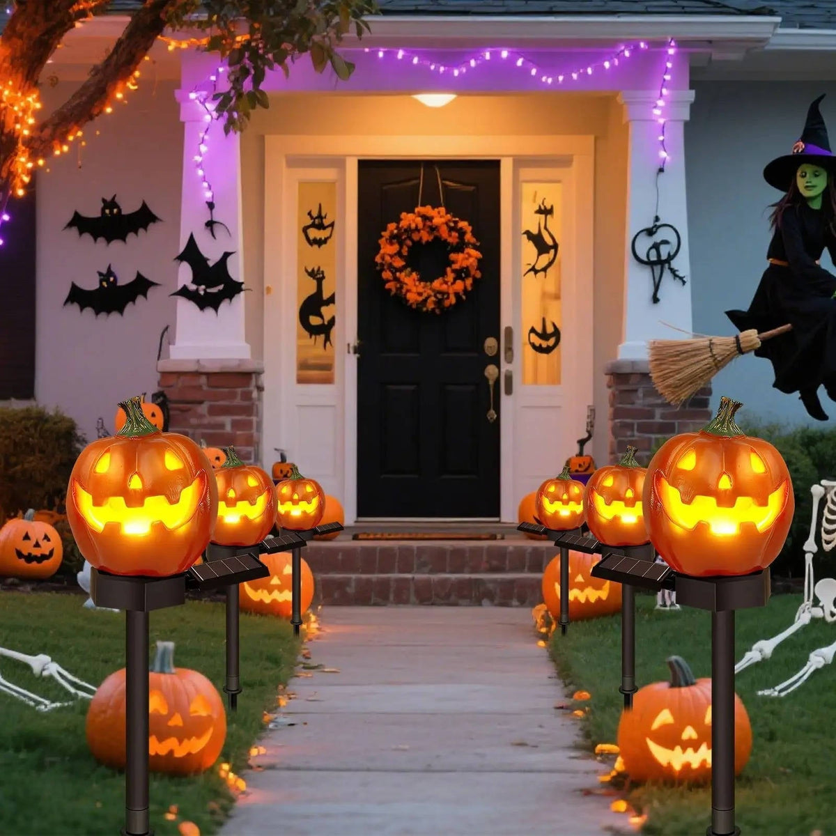 Solar pumpkin pathway lights glowing along a walkway at night