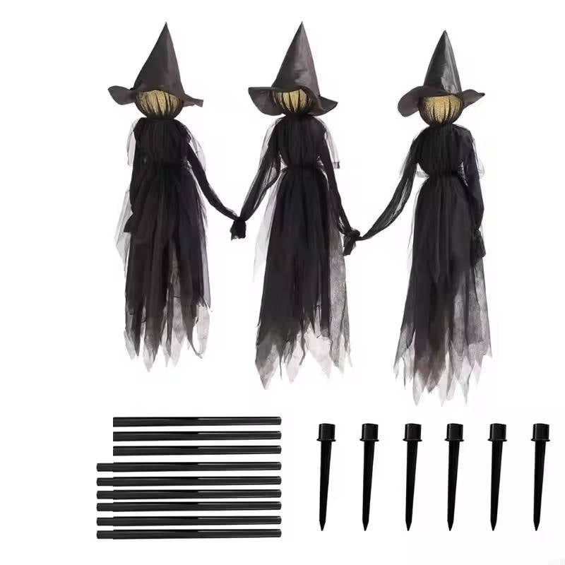 Witch figure trio arranged as a spooky indoor Halloween scene