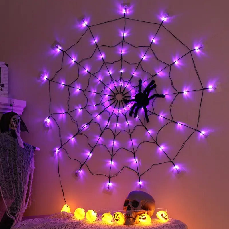 Copper wire spider web light shaped around a window frame