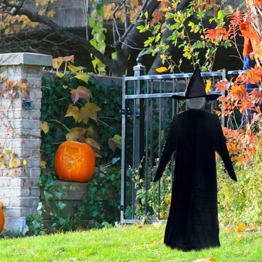 Witch Halloween yard decoration glowing at dusk