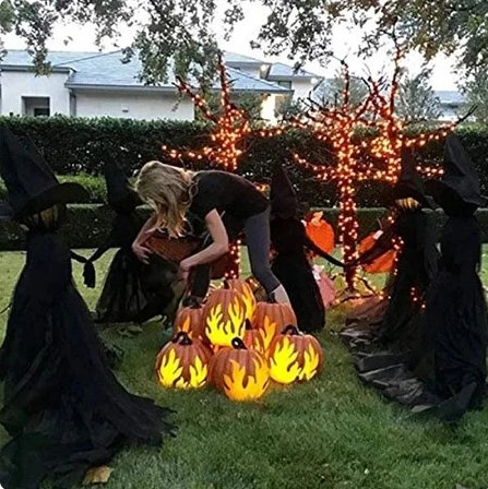 Witch yard stakes lined up in a hand-holding pose