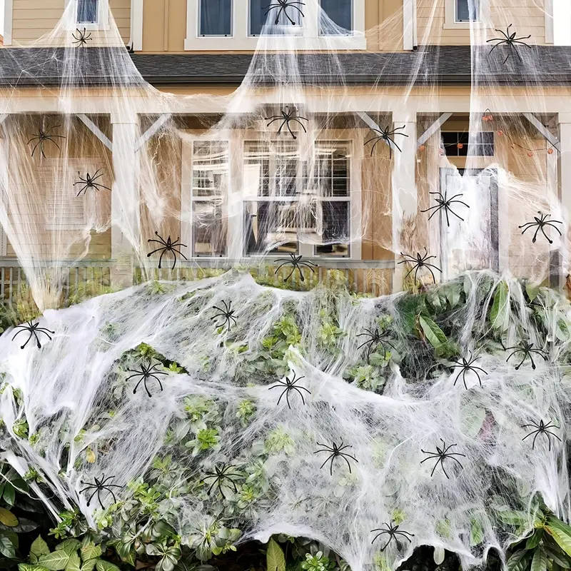 Stretch spider webbing draped across furniture for a Halloween scene