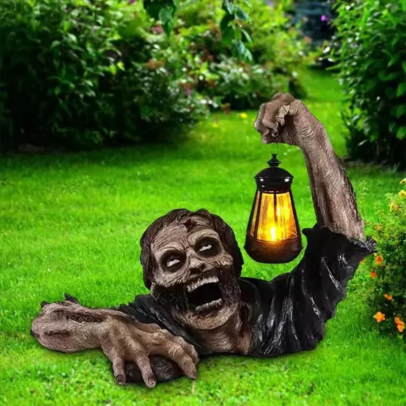Resin zombie Halloween decoration holding a lighted LED lantern