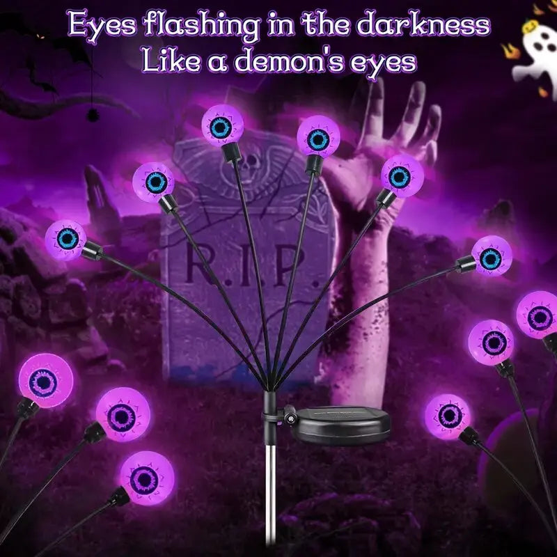 Glowing eyeball garden stakes lighting a spooky graveyard display