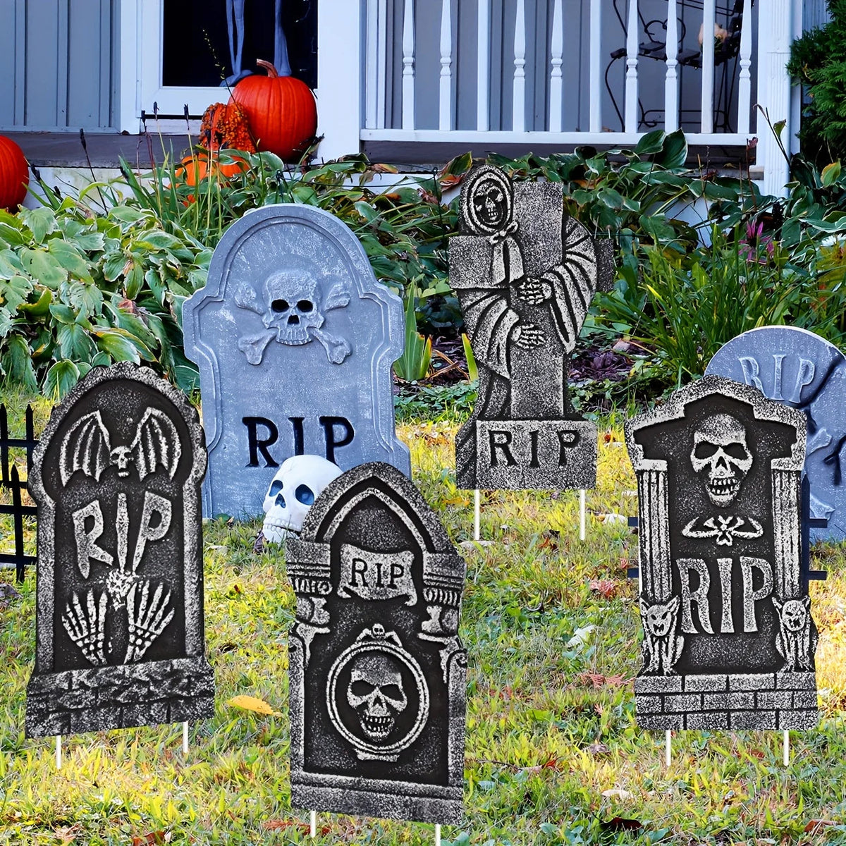 Halloween gravestone markers staked into a lawn for a graveyard scene