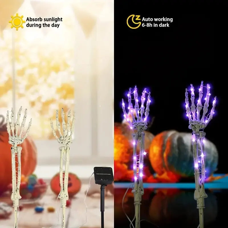 Skeleton hand solar light staked in grass along a walkway