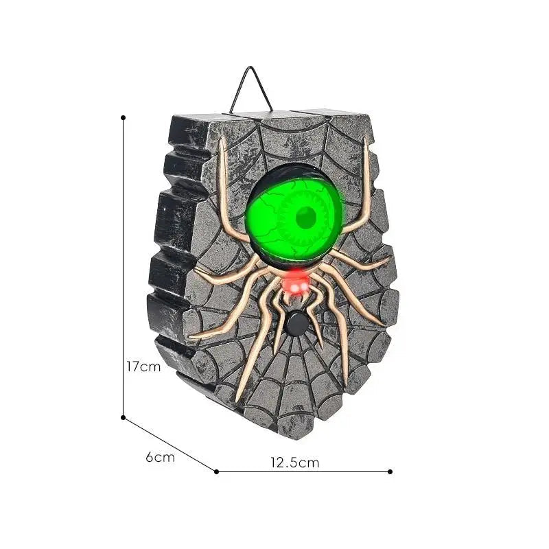 Halloween spider eye doorbell lighting up an entryway at night