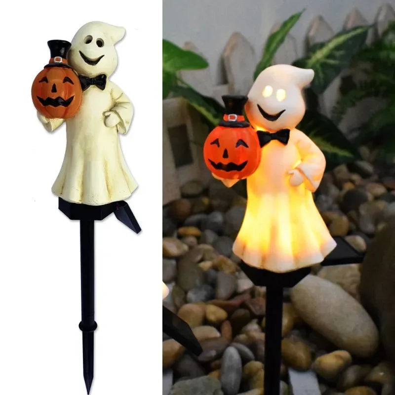 Halloween solar stake light set up in grass outside a home