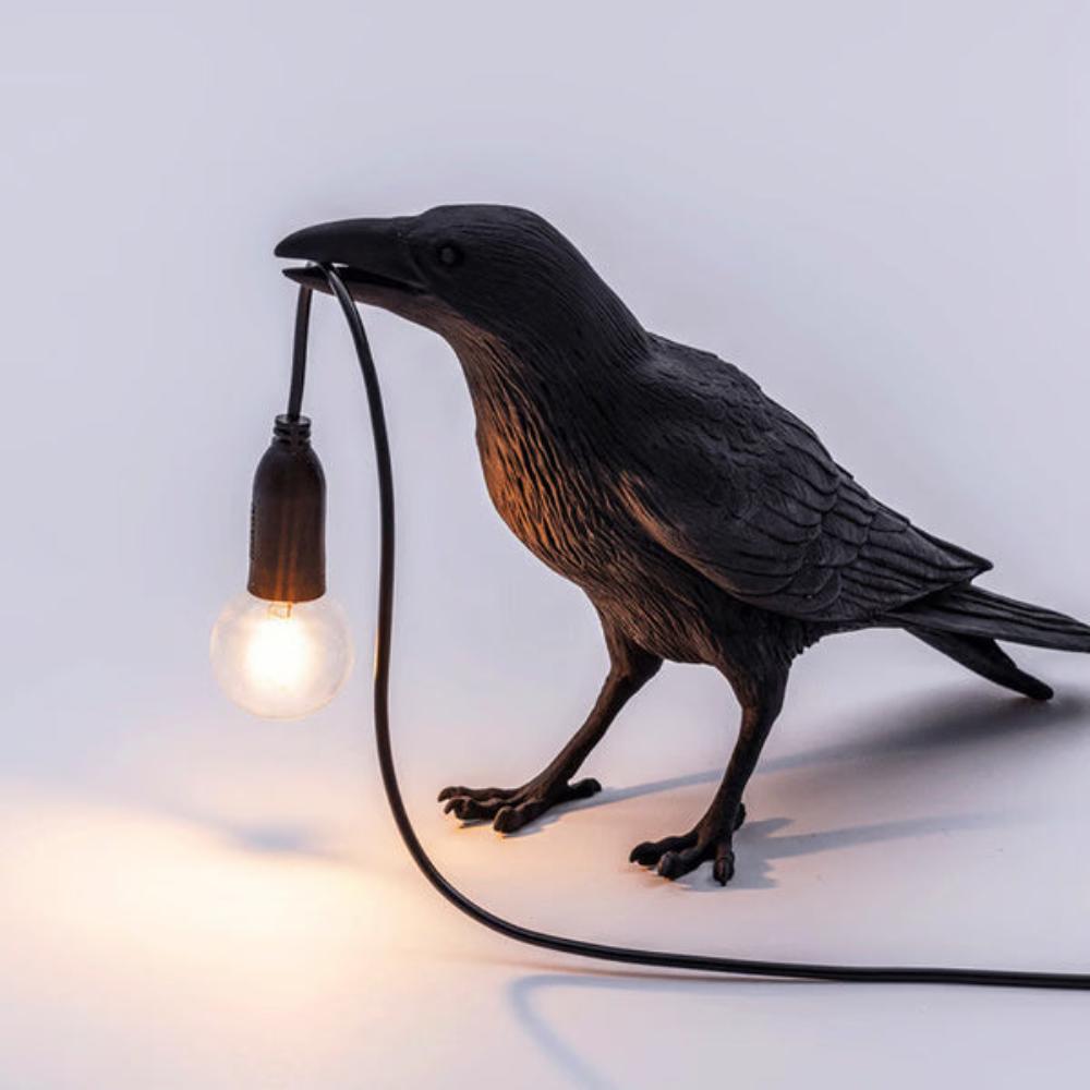 Crow figure lamp shown on a desk as a gothic accent light