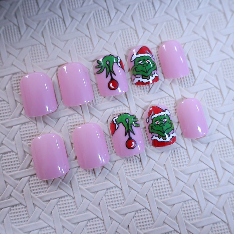 Christmas Press-On Nails with Green Cartoon Character Art | Santa Hat Accents in Pink and Red | Salon Finish at Home
