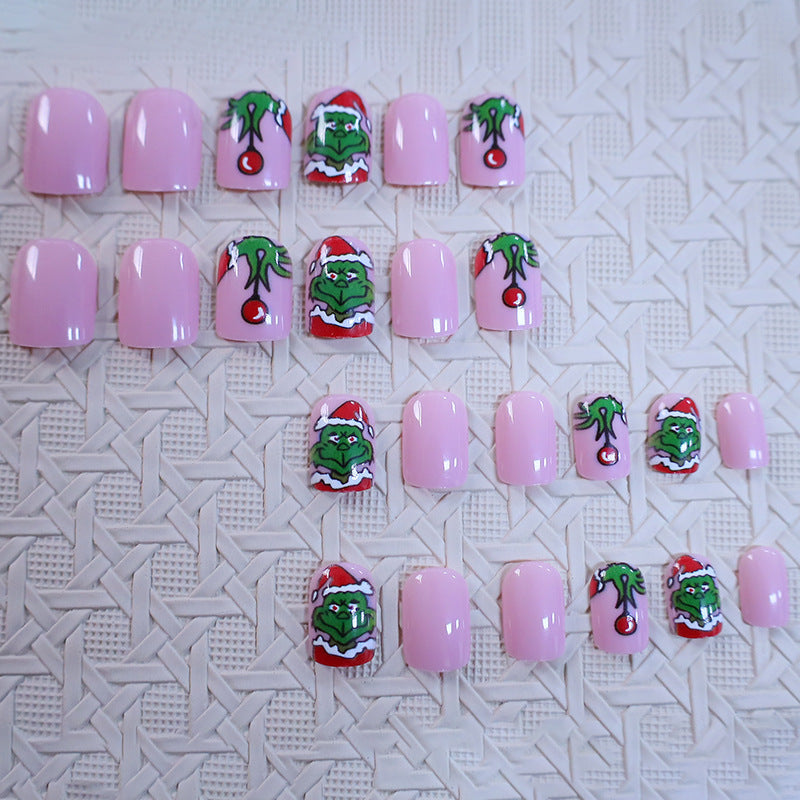 Christmas Press-On Nails with Green Cartoon Character Art | Santa Hat Accents in Pink and Red | Salon Finish at Home