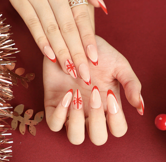 Stiletto Christmas Nails with Red Tips and Bow Motifs | Acrylic Press On Nail Set | Festive Manicure for Winter Parties