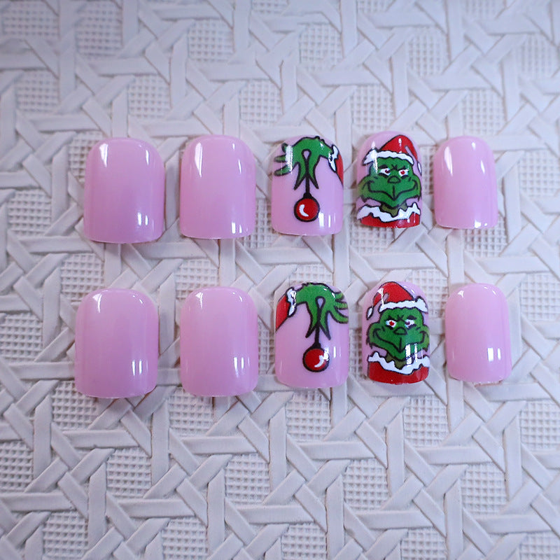 Christmas Press-On Nails with Green Cartoon Character Art | Santa Hat Accents in Pink and Red | Salon Finish at Home