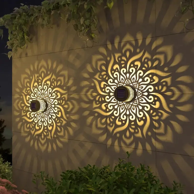 Warm white solar wall light glowing on a courtyard wall