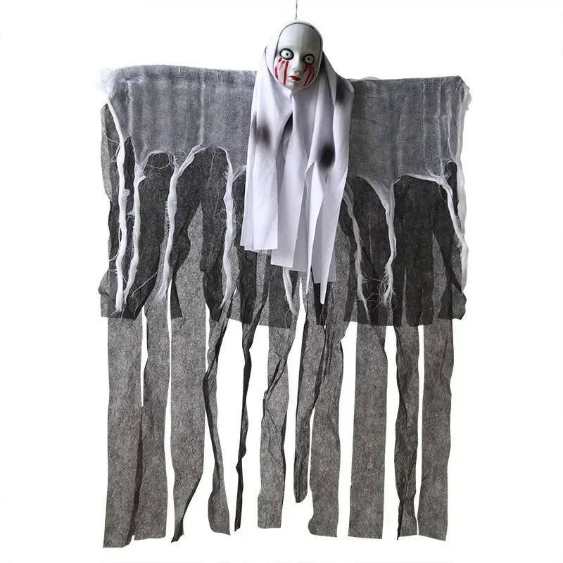 Skull ghost decoration with tattered shroud hanging from a tree