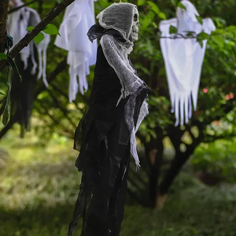 Hanging ghost skull Halloween decoration displayed outdoors at night