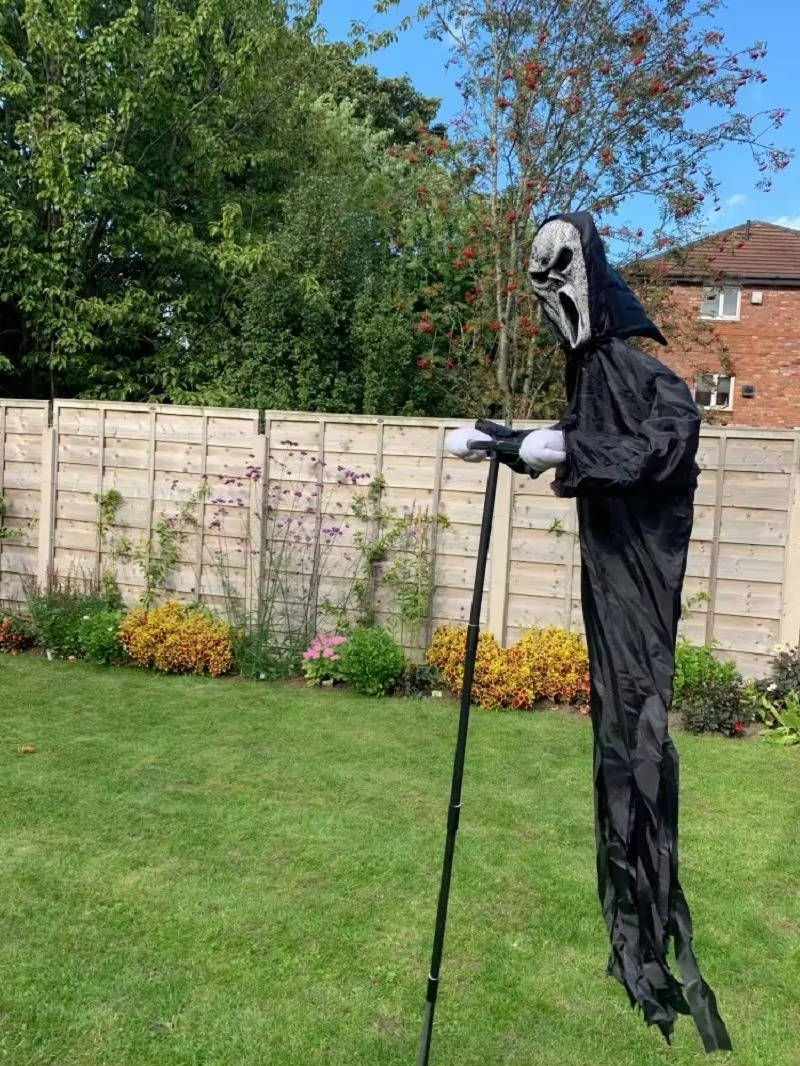 Outdoor ghost decoration with scary mask and realistic hands