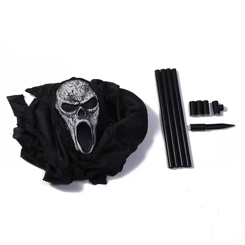 Ghost yard decoration with full black outfit in a garden setting