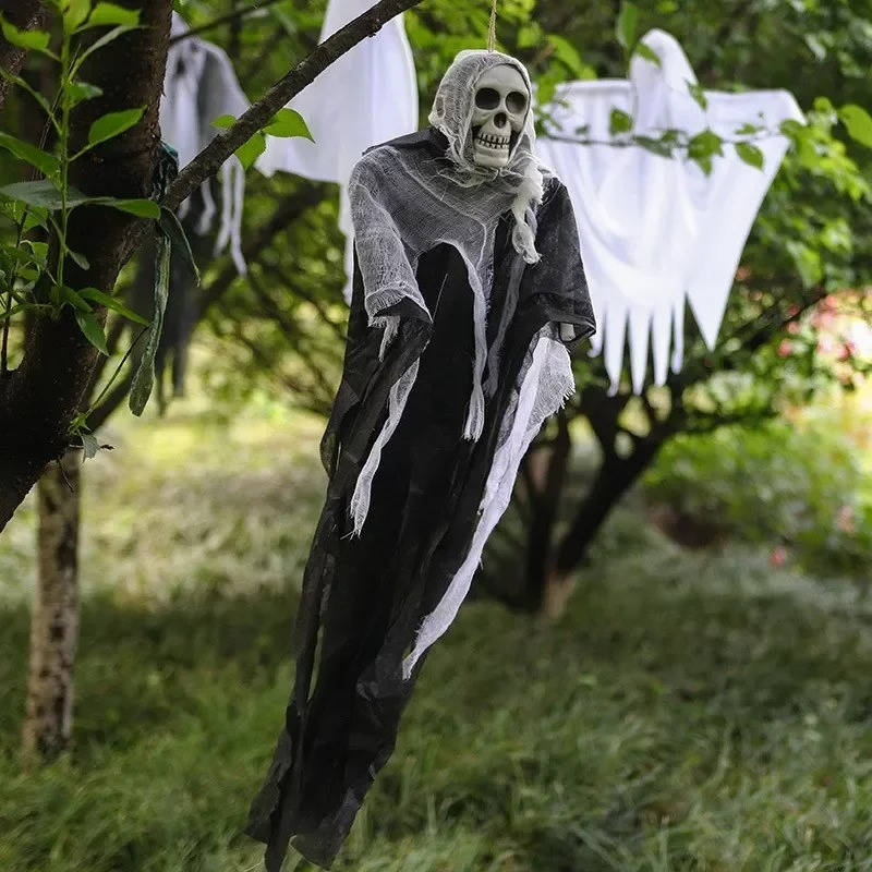 Hanging skull ghost decoration with hollow eye sockets close up