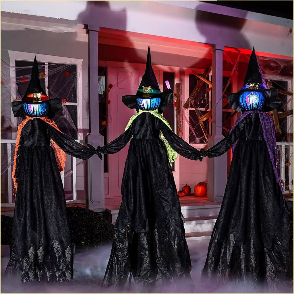 Faceless witch figures lit up in a yard at night