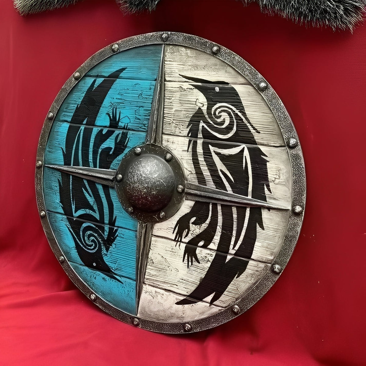Carved raven motif on the artisan wood shield face
