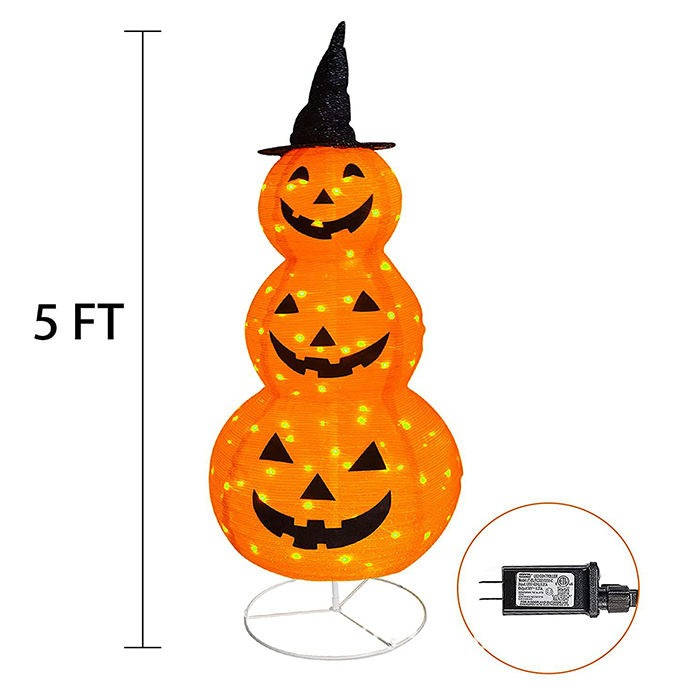 Halloween pumpkin decoration displayed in a garden after dark