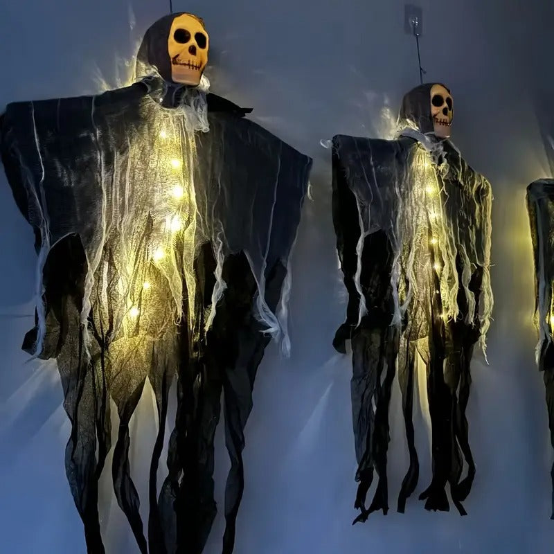 Glowing skull decoration hanging from a tree branch
