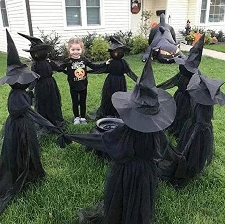 Sound-activated witch decoration lighting up at night