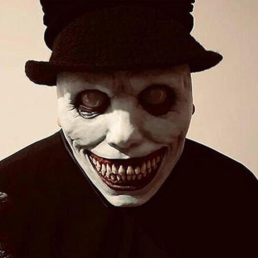 Close-up of the wide grin and yellow teeth on the demon horror mask