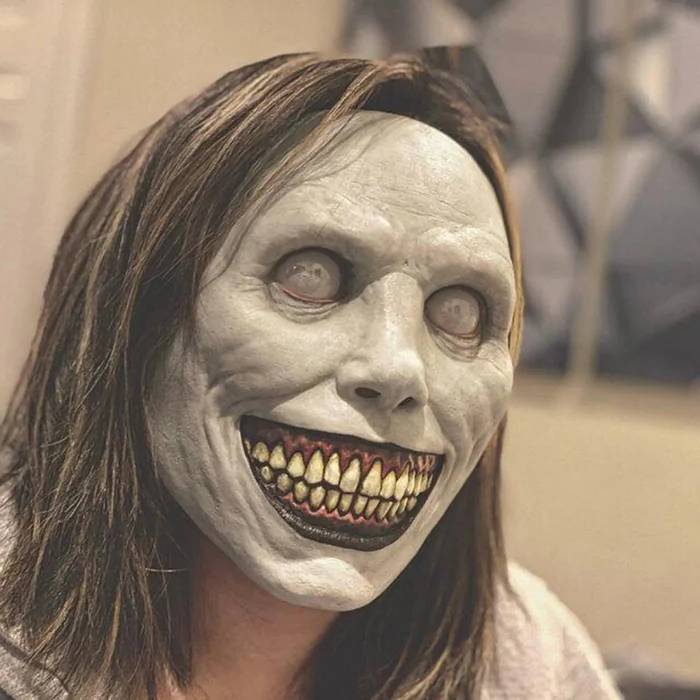 Evil grinning latex Halloween mask shown from the front