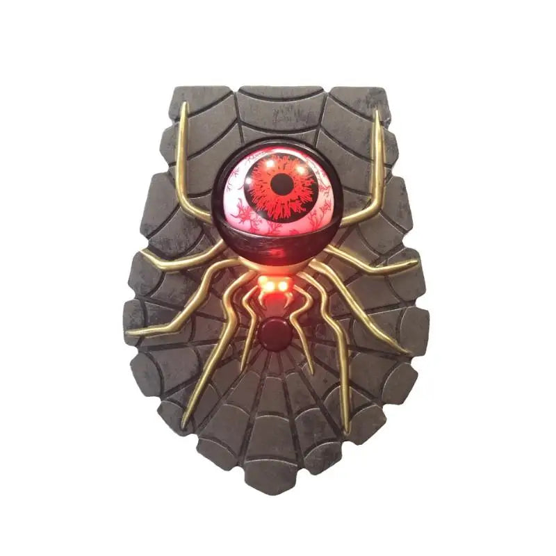 Red spider eye Halloween doorbell prop mounted beside a door